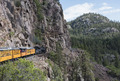 A Durango & Silverton Narrow Gauge Railroad (D&SNG) train proceeds along the rocky "Highline" ridge high above the Animas River Valley in La Plata County, Colorado LCCN2015632670