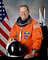 David M. Brown, NASA photo portrait in orange suit