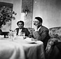 Hitler sitting at a table