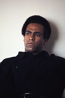 Huey P. Newton in living room.jpg
