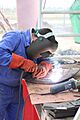 Welder on Morón Air Base repairs damage to an elevated water tower on base