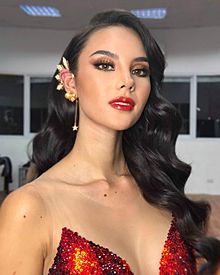 Catriona Gray with iconic tristar and sun earpiece, in Mak Tumang Swarovski gem-embellished "Mayon" evening number.jpg