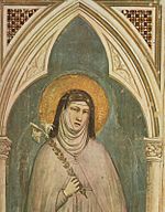 Archivo:Fresco depicting Clare of Assisi holding a lily