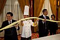 Barack Obama and Hu Jintao participate in a noodle-making demonstration
