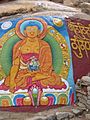 Buddha painted on a rock wall in Tibet