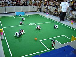 Archivo:Aibos playing football at Robocup 2005