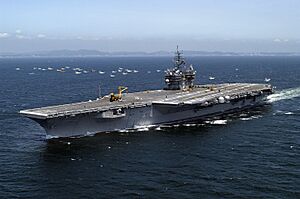 Archivo:US Navy 050517-N-0120R-127 The conventionally powered aircraft carrier USS Kitty Hawk (CV 63) sails past a small group of Japanese fishing vessels and heads toward Sagami Bay