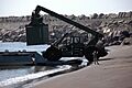 US Navy 070203-N-8797R-048 A Sailor assigned to Beach Master Unit One (BMU-1) directs the offload of a container from a barge ferry in Puerto Quetzal, Guatemala, for Humanitarian Support over the Shore (HSOTS) 2007