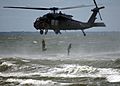 US Navy 070721-N-8949D-002 Navy SEALs exit a helicopter before securing the beach during a capabilities demonstration at the annual East Coast SEAL reunion
