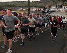 Joggers run past a Guantanamo border gate