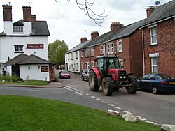 Tractor passing the Golden Lion Inn, Tipton St John - geograph.org.uk - 1285999.jpg