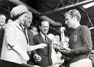 The Queen presents the 1966 World Cup to England Captain, Bobby Moore. (7936243534).jpg