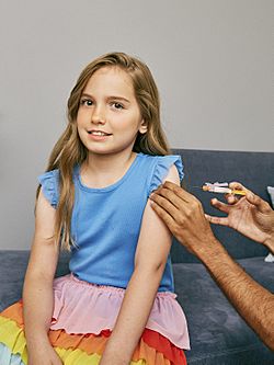Young girl about to receive a vaccine in her upper arm (48545990252).jpg