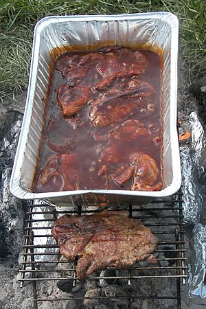 Archivo:Pork steaks cooking-1