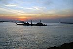 US Navy 070206-N-0000B-001 As the sun rises over Puerto Quetzal, Guatemala's largest Pacific Ocean port, an Improved Navy Lighterage System (INLS) Causeway Ferry continues deployment
