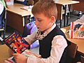 First grader reads a certificate ABC book read