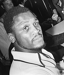 Joe Frazier reading newspaper cropped.jpg