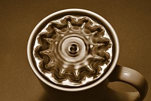 A cup of black coffee vibrating in normal modes