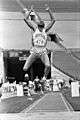 Mike Powell mid-leap in long jump, 1986