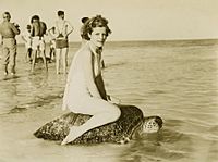 Woman riding turtle at Mon Repos.jpg