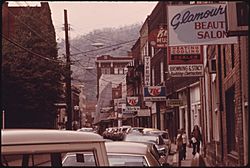 MAIN STREET OF LOGAN, WEST VIRGINIA, SHOWING A NARROW STREET WITH PARKING ON ONLY ONE SIDE WHICH IS TYPICAL IN MANY... - NARA - 556422.jpg