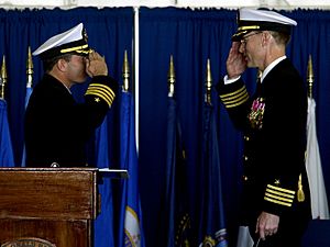 Archivo:US Navy 051117-N-4776G-077 Capt. James A. Symonds, right, turns over command of the Nimitz-class aircraft carrier USS Ronald Reagan (CVN 76), to Capt. Terry B. Kraft during a change of command ceremony
