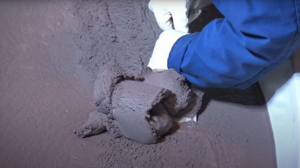 Archivo:Ammonium Perchlorate Composite Propellant (uncured) is shaped by a Worker