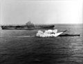 USS Halibut (SSGN-587) firing a Regulus missile next to USS Lexington (CV-16), 25 March 1960