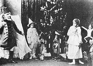 Nutcracker -Scene from Act I -Sergei Legat as Nutcracker, Stanislava Stanislavovna Belinskaya as Clara, & Unidentified as a Gingerbread Soldier -1892.jpg