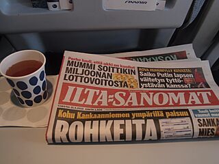 Ilta-Sanomat on board an aeroplane.jpg