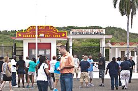 Off duty GIs, on a tour of the Guantanamo base, mingle just inside the gate to Cuba -a