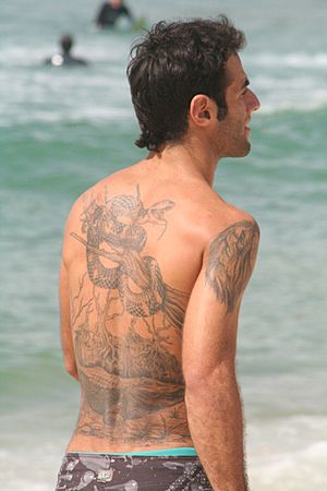 Man with tattoo on his back - at the beach.JPG