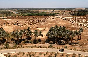 Archivo:US Navy 030529-N-5362A-001 A U.S. Marine Corps Humvee vehicle drives down a road at the foot of Saddam Hussein's former Summer palace with ruins of ancient Babylon in the background