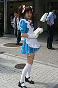 Promotional maid handing out flyers for a new maid café in Akihabara