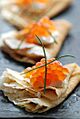 Blini with sour cream and red caviar