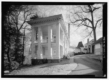 General view looking from the northwest in the direction of the north (front) facade; view includes covered causeway from Building No. 120, shown in the background - National HABS MD,16-SILSPR,2L-4