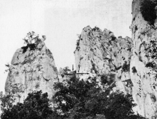 "Las cuevas de 'La Leze' y de 'Los Gentiles', el yacimiento de 'Allaran'" (1929), de Enrique Eguren - vista de frente de la cueva; en primer término, los picachos, al fondo la cueva.png
