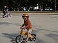 Balance bike ridden solo and conventional bike ridden with help of adult