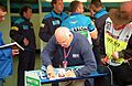 Murray Walker signs his yearbook at the 1995 British GP, Silverstone (49713882827)