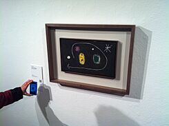 1 visitor scaning QRPedia codes at Fundació Joan Miró.JPG