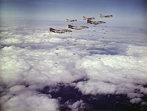 F-4B Phantoms of VF-161 and A-7C Corsairs of VA-86 drop bombs on Vietnam in March 1973.jpg