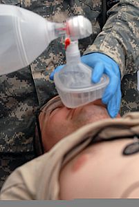 U.S. Army Capt. Anna Gray, left, an intensive care unit nurse with the 4224th U.S. Army Hospital (USAH), uses a CPR mask to pump air into Pfc. Andrew Cowden, a medic role playing as a casualty also with 110613-A-WR822-041