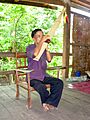 A Mangkong man plays khene in Laos