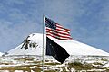 The United States flag flies above the Alaska State flag at the Kodiak Launch Complex in Kodiak Alaska. The 114th Combat Communications Squadron (CBCS), Patrick AFB, Florida, along - DPLA - 69356cad07c8f3850c1f6b3ec479300f