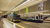 Metro bus and Link light rail passing at University Street Station (2010).jpg