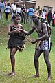 Acholi couple in preparation to dance dressed in goats skin and fabric