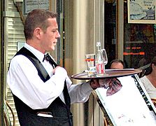 Waiter in a terrace cafe in Paris France