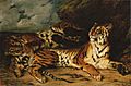 Young tiger playing with its mother