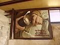 Panel dedicado al trabajo del cantero en la entrada a la casa taller del Artesano
