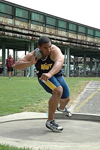 US Navy 050429-N-7975R-001 Midshipman 4th Class Darryl Hunter side steps into position for his first attempt in the shot put event at the Penn Relays.jpg